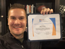 Picture of Matt Phillips holding PMIW Certificate of Appreciation