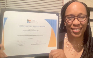 Selfie of Dr. Valerie Williams holding her PMIW Certificate of Appreciation