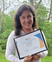 Niki Weiss holding her PMIW Certificate of Appreciation